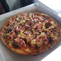 Pizza with ham and chunky toppings