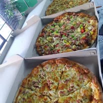 Two fresh pizzas side by side