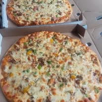 Two golden cheesy pizzas